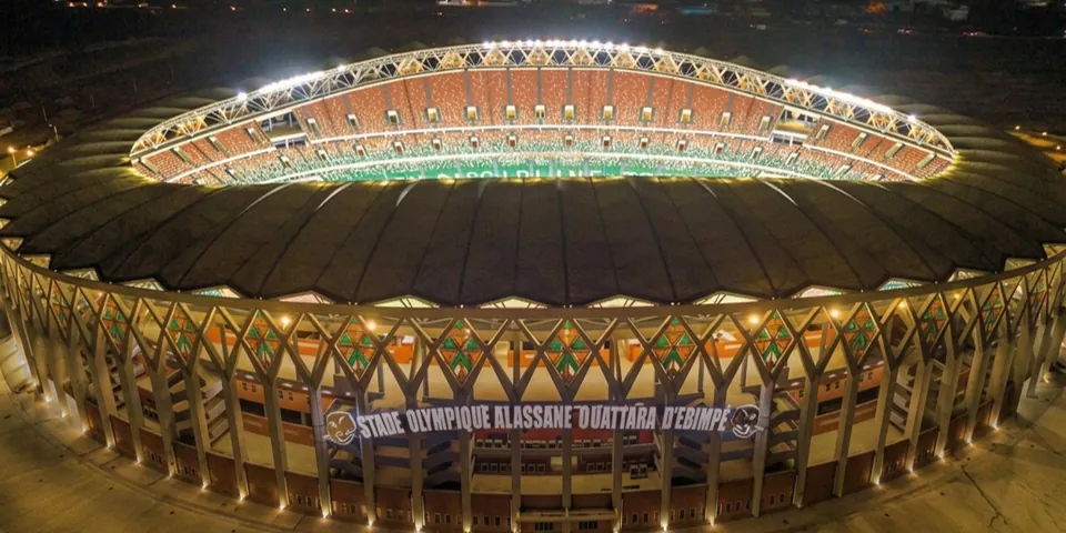 The Alassane Ouattara Olympic Stadium in Ebimpé, lit at night